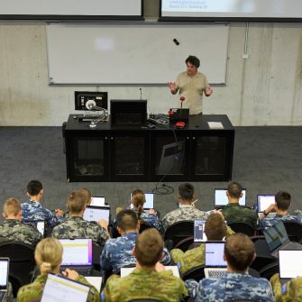 ADFA Canberra 麻豆社 lecturer and students with laptops in lecture room