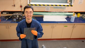 Dr Di He with a sample of carbon fibre recycled using a method he developed.