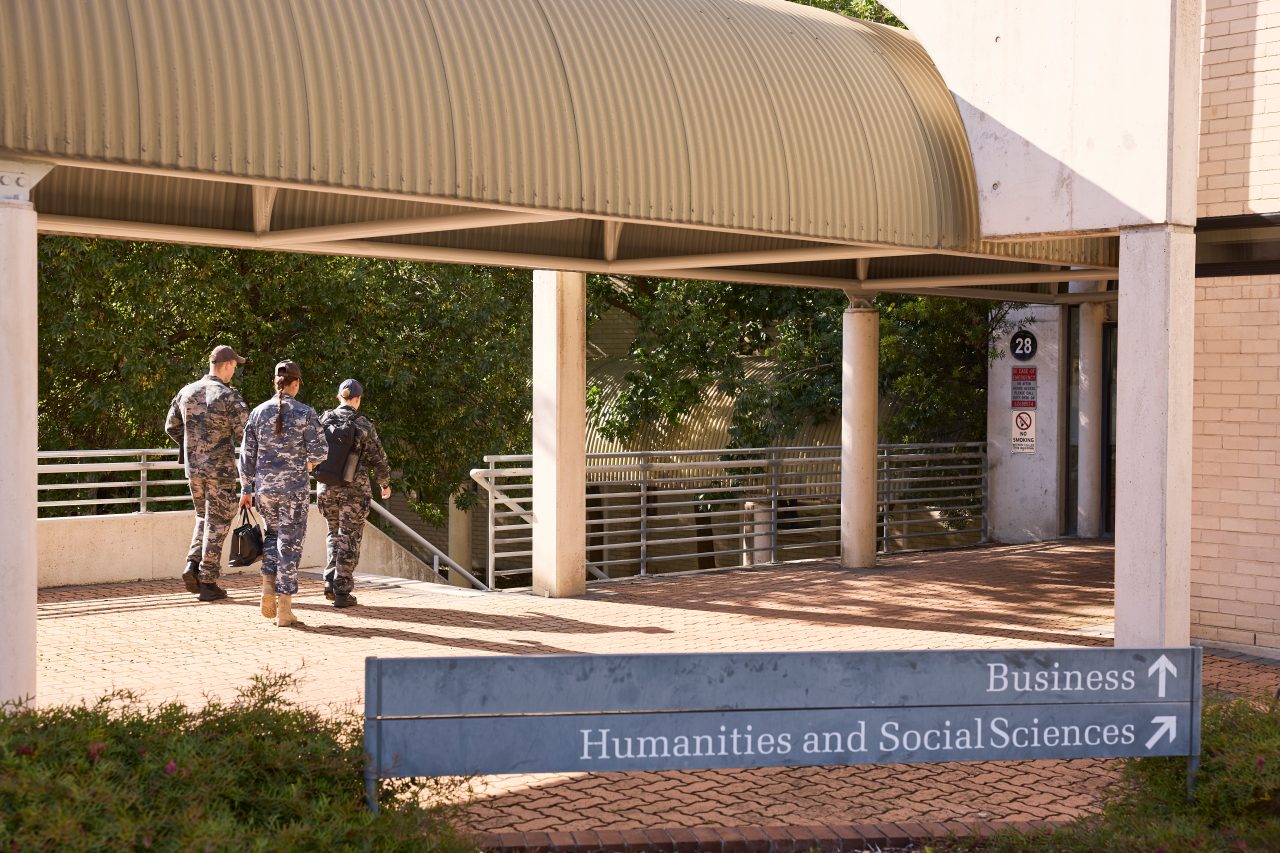Students walking towards business and humanities and social science buildings